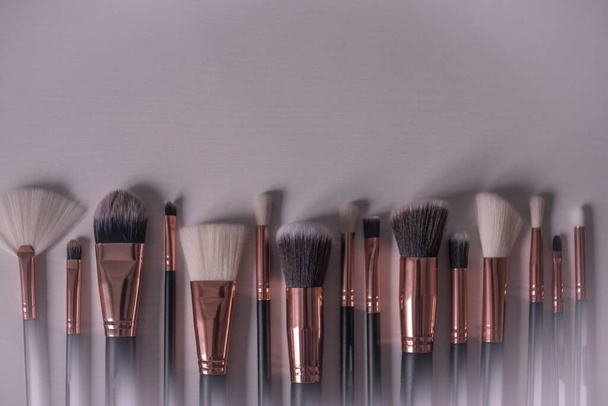 Brushes for artistic makeup of different sizes. Light background, vignetting, copy space. - Foto, Bild