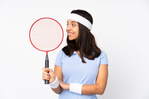 Young badminton player woman over isolated white background looking side - Photo, Image