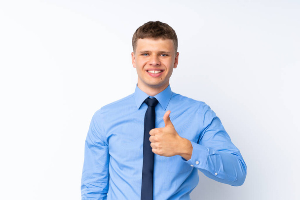 Young handsome businessman giving a thumbs up gesture - Фото, зображення