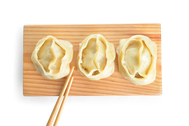 Board with oriental dumplings on white background - Photo, Image