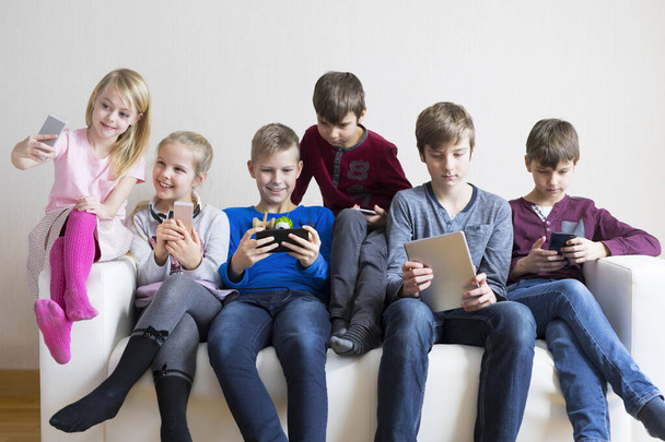 Kids using gadgets. Device addiction concept. - Фото, зображення