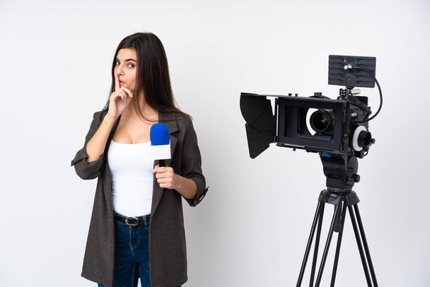 Reporterin hält ein Mikrofon in der Hand und berichtet Nachrichten über isolierten weißen Hintergrund und macht Schweigegeste - Foto, Bild