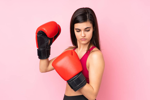 Young sport woman over isolated pink background with boxing gloves - Photo, Image