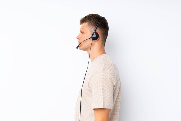 Young handsome man over isolated white background working with headset - Fotoğraf, Görsel