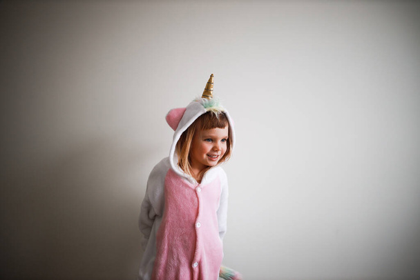 portrait of a todder in unicorn pyjama not looking at camera - Photo, Image
