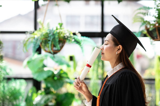 attrayant belle asiatique diplômé femme en chapeau et robe sourire avec certifié sentiment si fier et bonheur dans le succès diplômé jour, concept de réussite scolaire - Photo, image