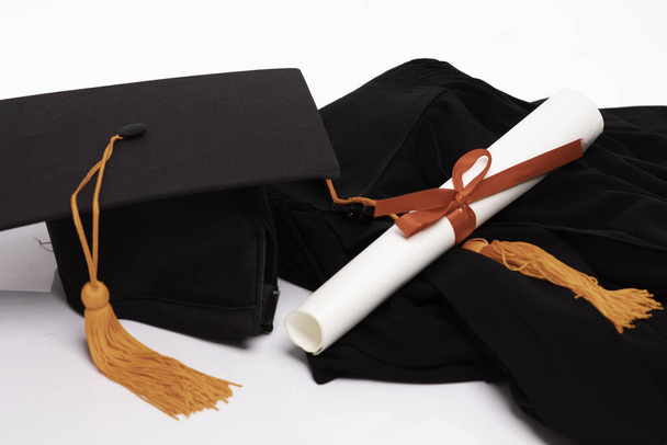 Graduation gown cap and certificated on white background,Education Success Concept - Fotografie, Obrázek