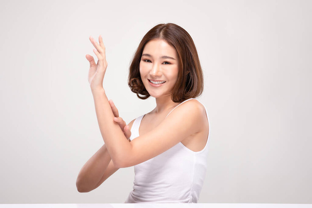 Beautiful Asian woman with short hair looking at camera smile with clean and fresh skin Happiness and cheerful with positive emotional,isolated on gray background,Beauty and Cosmetics Concept - Foto, imagen