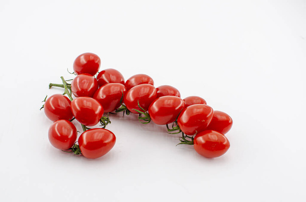 Fresh cherry tomatoes on a branch isolated on white background - Foto, Imagem