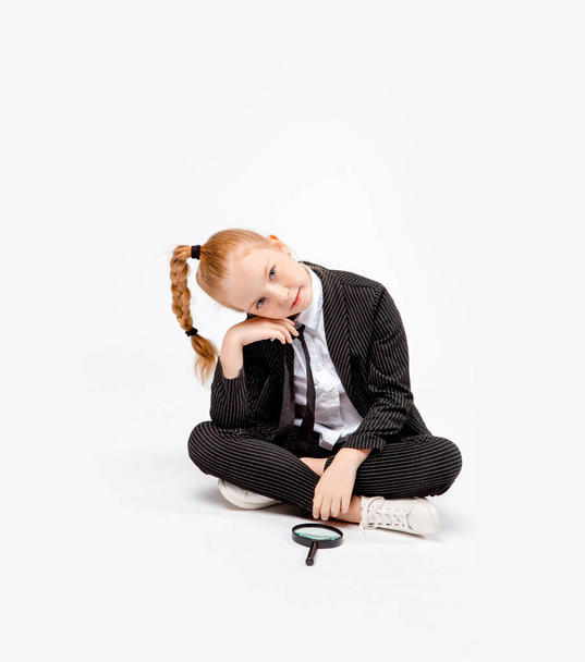 girl in a business black suit sits cross-legged  - Photo, Image