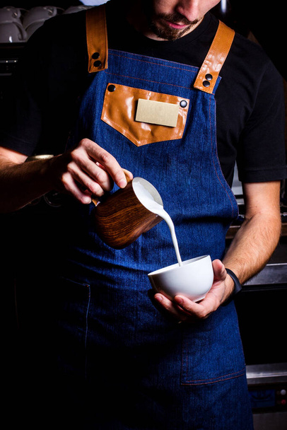 barista pours milk into the  coffee - Foto, Imagem