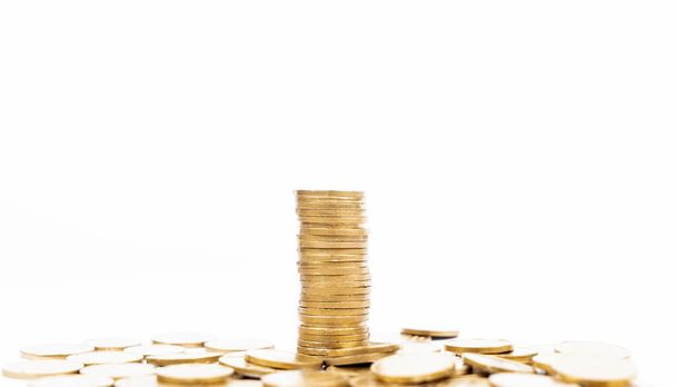 Golden coins piled on white background. Business finance concept - Fotoğraf, Görsel