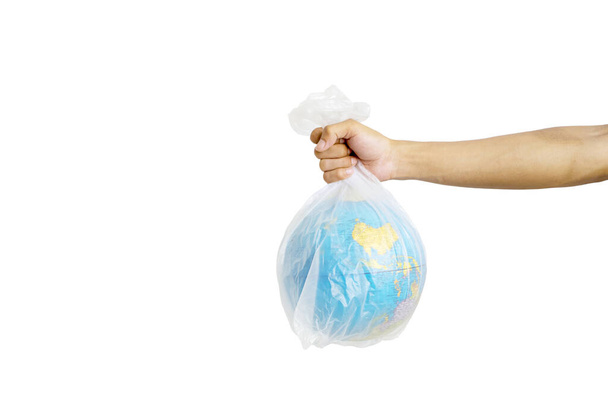 Hand holding globe in plastic bag, shot in the studio isolated on white background - Foto, Bild