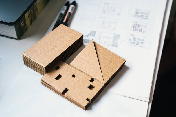 Architect Desk With Cardboard Architectural Model and Hand-drawn Plan Sketches (em inglês). Foco seletivo
 - Foto, Imagem