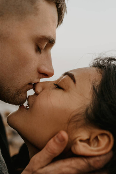Portrait of a beautiful couple in love. Tender kiss - Foto, Imagem