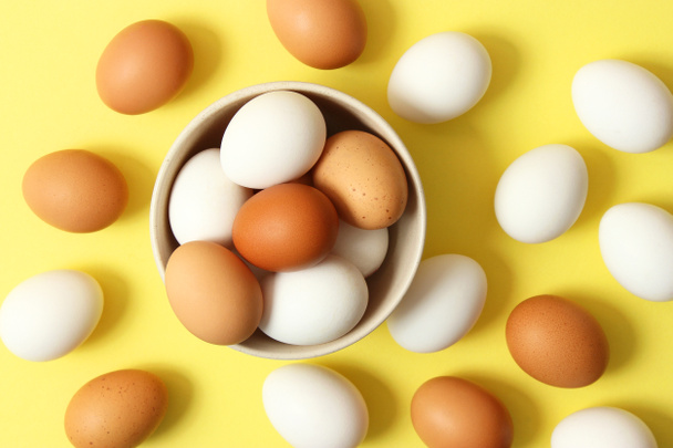 куриные яйца на цветном фоне. Сельскохозяйственные продукты, натуральные яйца
. - Фото, изображение