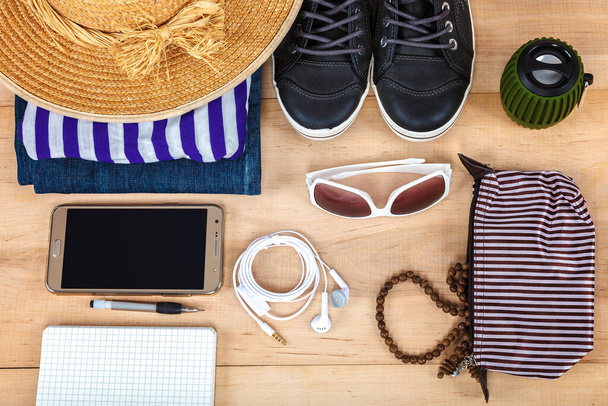 Travel accessories and clothes on wooden background. - Photo, Image