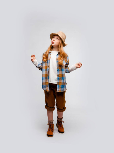 cute long-haired emotional girl in traveler clothes explores something - Fotografie, Obrázek