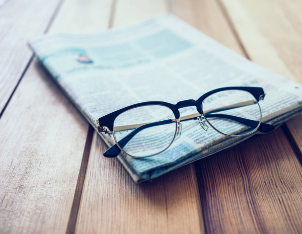Glasses with Newspaper on wooden table - Φωτογραφία, εικόνα