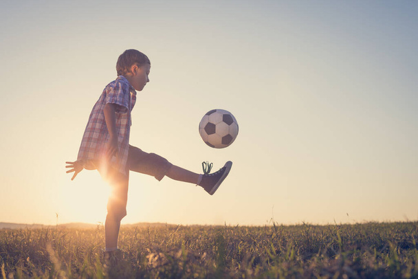 Young little boy playing in the field  with soccer ball. Concept of sport. - Фото, зображення