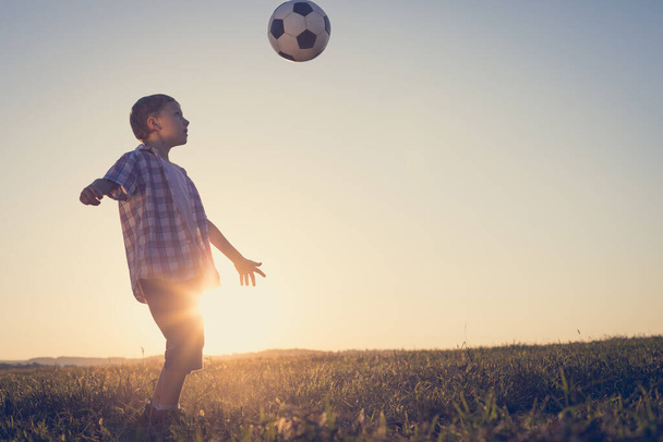 Young little boy playing in the field  with soccer ball. Concept of sport. - Fotoğraf, Görsel