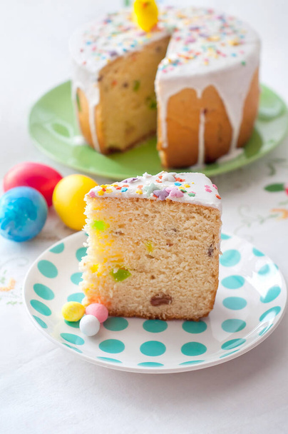 A piece of cake on a plate on the background of the Easter table - Photo, image