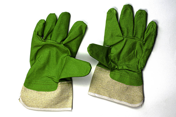 paire de gants de travail avec accents verts sur le fond blanc
 - Photo, image