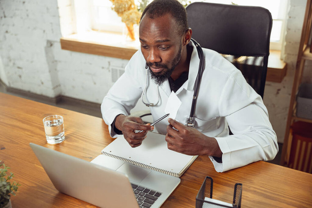 African-american doctor consulting for patient, working in cabinet, close up - Photo, image
