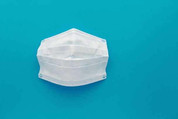 Medical mask, Medical protective masks on blue background. Disposable surgical face mask cover the mouth and nose. Healthcare and medical concept. - 写真・画像