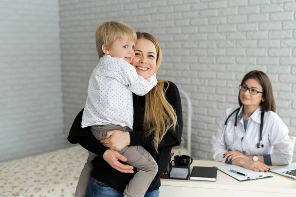 Porträt von Mutter und Kind bei einem Arzttermin. Kinderarzttermin mit Mutter und Kind im Krankenhaus - Foto, Bild