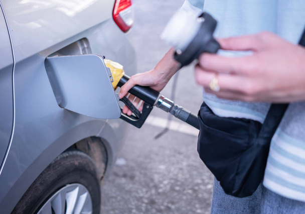 Woman refilling gasoline oil with fuel at the refuel station - Photo, Image