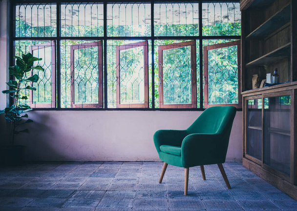 Old room with green armchair and green nature in window. - Fotoğraf, Görsel