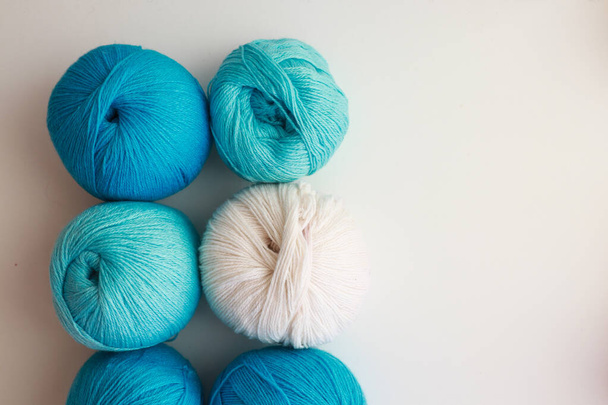 balls of blue thread for knitting on a white background - Foto, Imagen