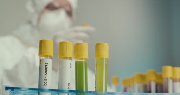 Close-up Laboratory scientist laboratory assistant gloves test tubes pipette virus reagents vaccine comparison experiment - Video, Çekim