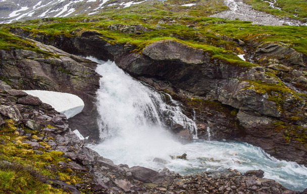 Waterfall and river with clear water, formed by melting glacier and snow high in the mountains. Jostedalsbreen National Park. Norway - Photo, Image