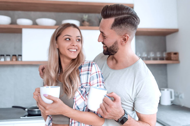 young couple in love in the kitchen in a good morning - Fotoğraf, Görsel