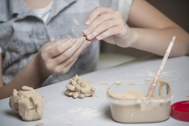 Girl make toy from clay - Φωτογραφία, εικόνα