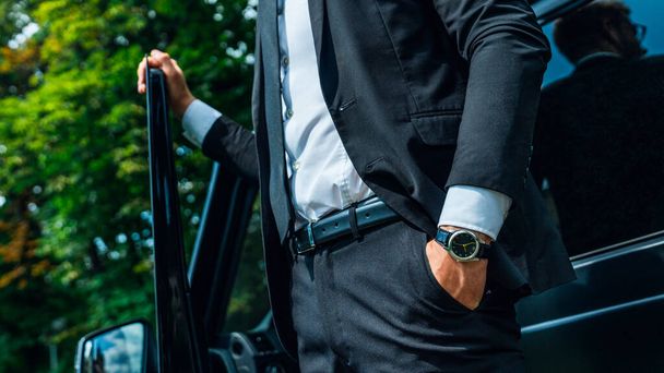 Cropped image of a modern businessman standing near his car outside - 写真・画像