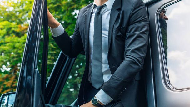 Cropped shot of confident young businessman coming out of his car - Fotó, kép