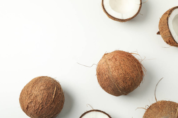 Flat lay with coconut on white background, top view - Foto, afbeelding