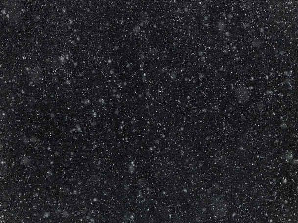 Texture of flakes of falling snow on a dark  - Photo, Image