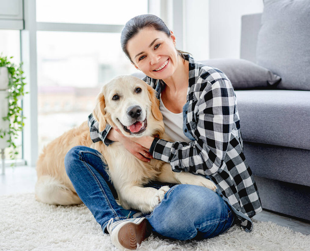 Happy woman with adorable dog indoors - Fotografie, Obrázek