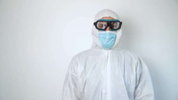 Portrait of a virologist in protective coverall, glasses and mask - Кадры, видео