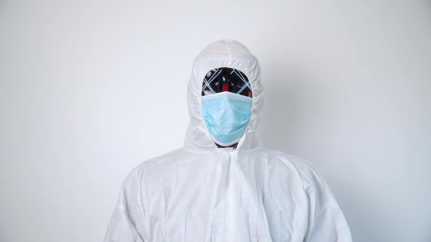 Portrait of a virologist in protective coverall and black mask. Atypical virologist - Séquence, vidéo