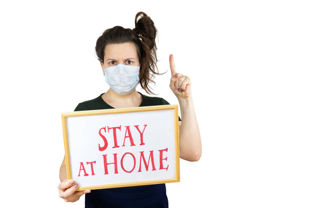 Woman holding sign Stay Home Save Lives global message coronavirus. Quarantine to fight COVID-19 pandemic, isolated. - Foto, imagen