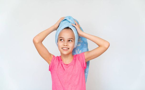 teenager girl in blue towel and pink t-shirt. - Zdjęcie, obraz