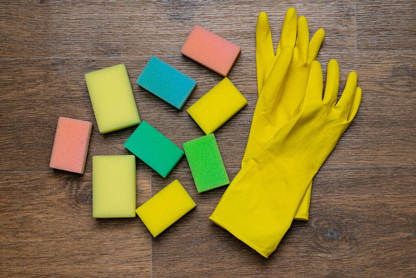 yellow rubber gloves and washcloths on wooden background - Photo, Image