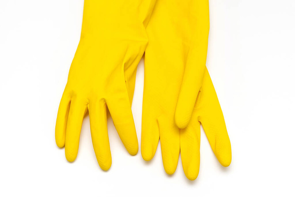 白い背景に黄色のゴム手袋 - 写真・画像