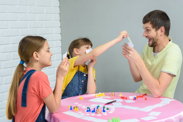 Children draw dad's card in a fun board game - Photo, Image