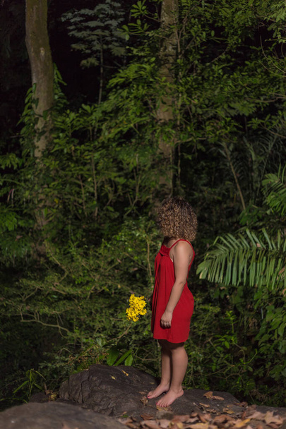 Woman in red dress and yellow flowers - Photo, Image